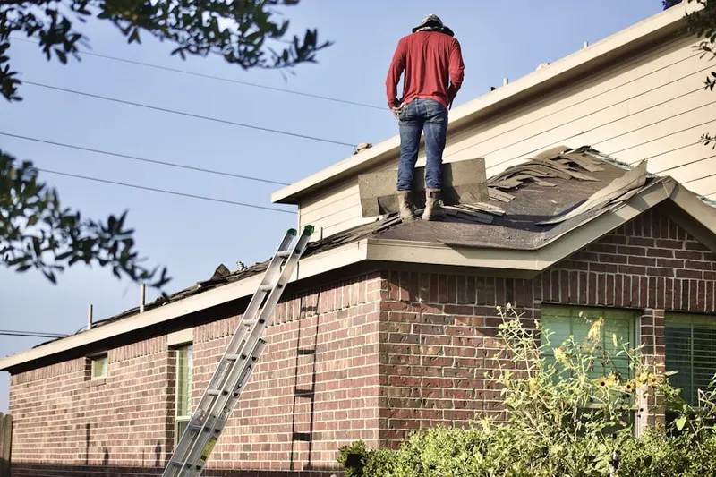 Professional roofer working on a residential roof in The Dalles